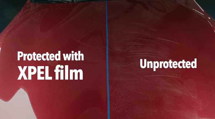 A red surface, split vertically. The left side, labeled Protected with XPEL film, is smooth. The right, Unprotected, is heavily scratched.
