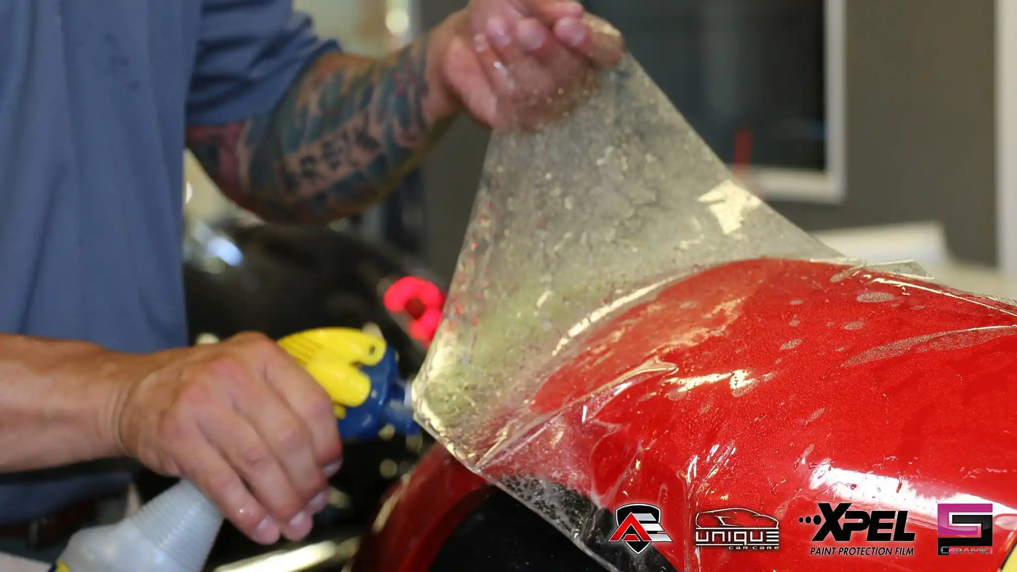 Close-up of paint protection film being applied to a Ferrari 458 Speciale body panel