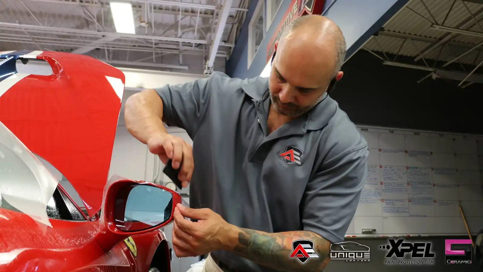 Paint protection film being applied to the side mirror of a Ferrari 458 Speciale