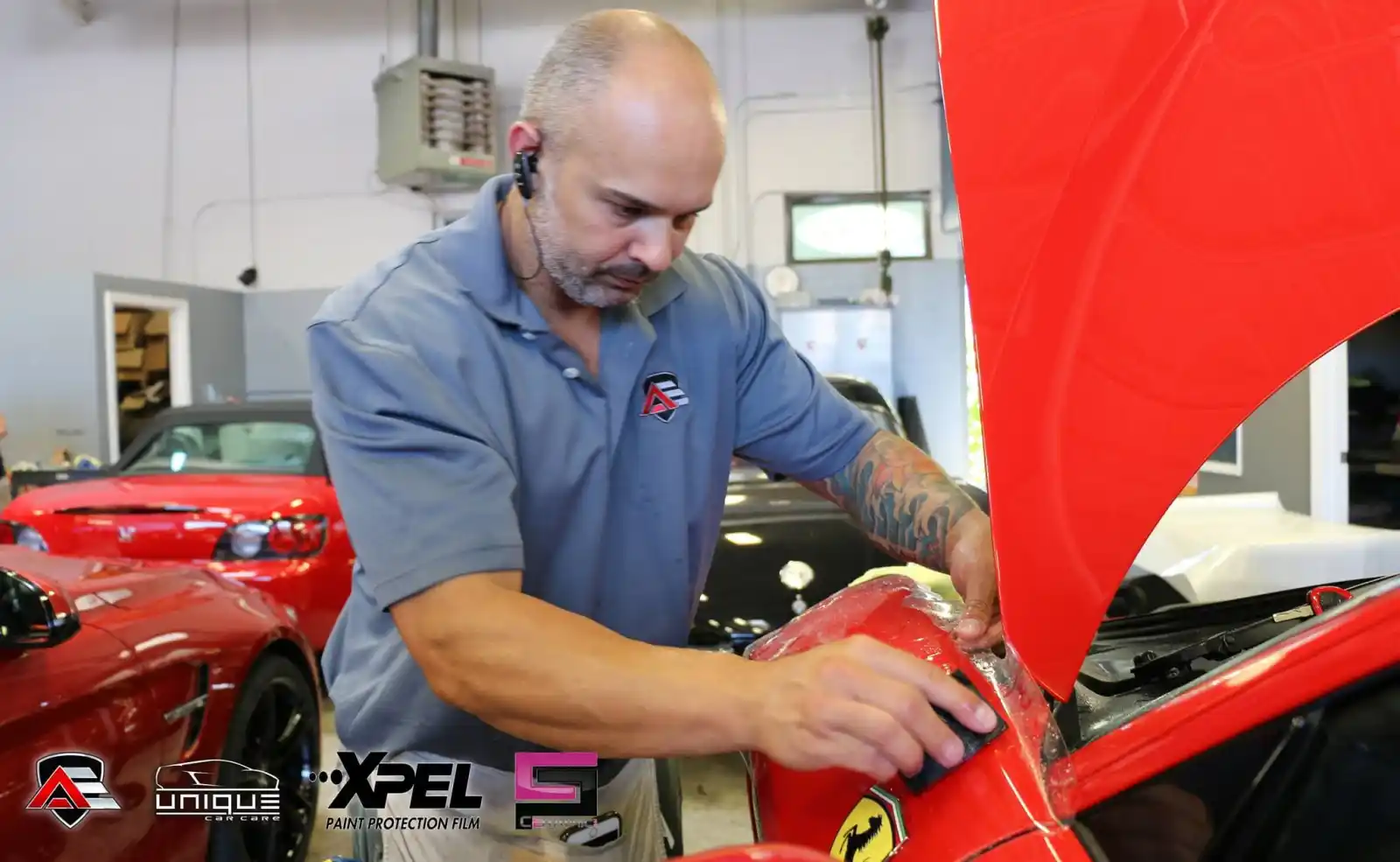 Technician applying paint protection film to a Ferrari 458 Speciale fender