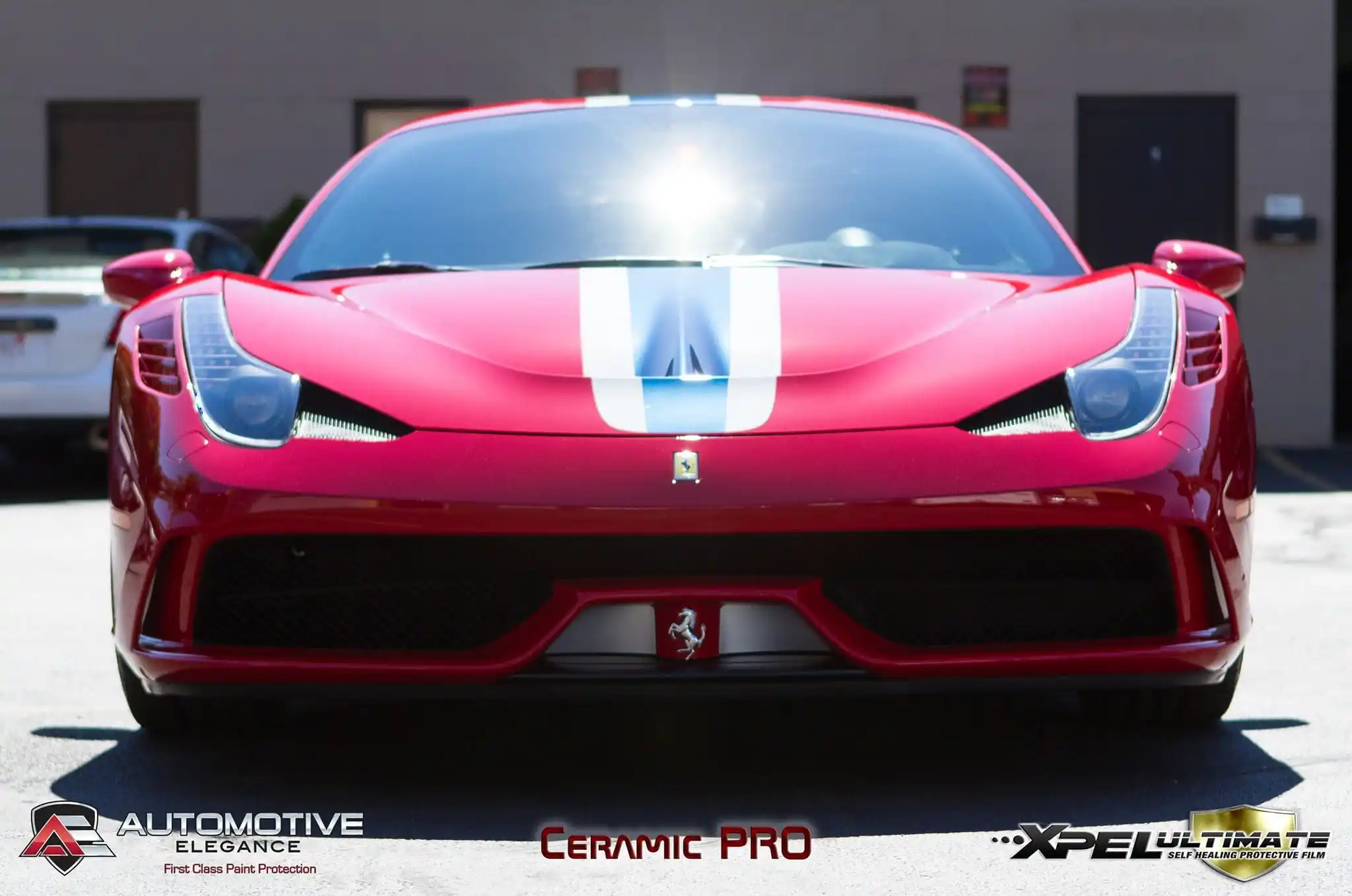 Red Ferrari 458 Speciale with black racing stripe parked outdoors