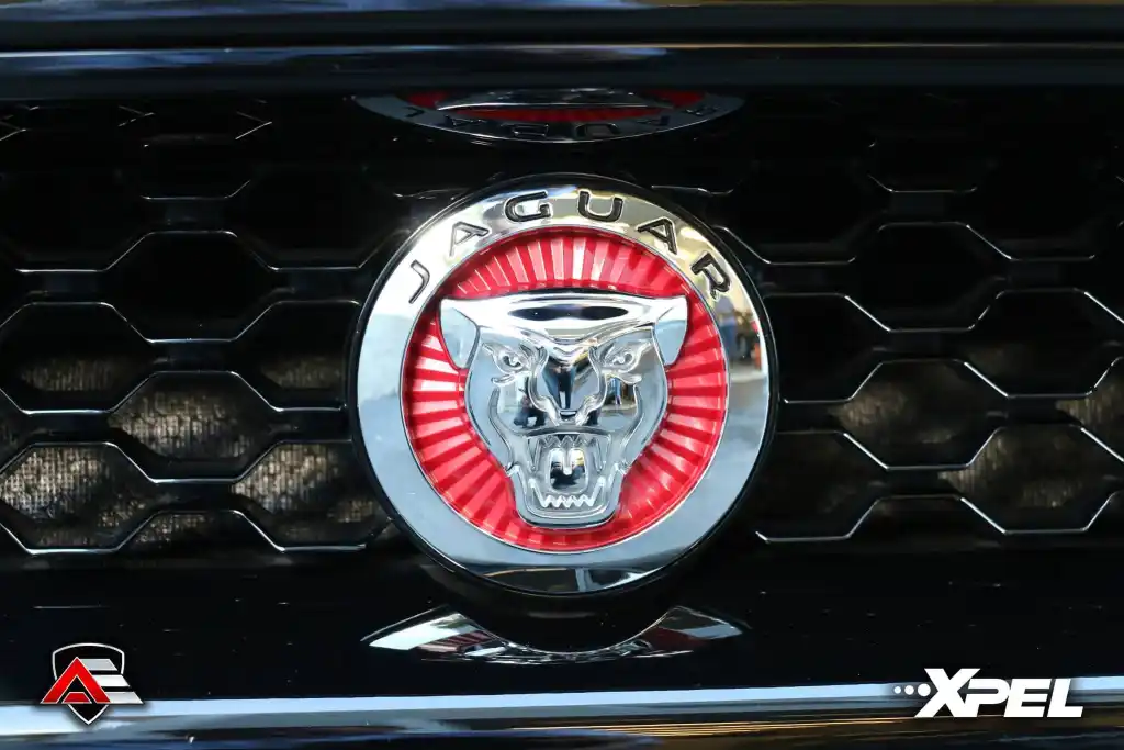 Close-up of Jaguar grille emblem on a black Jaguar F-TYPE R