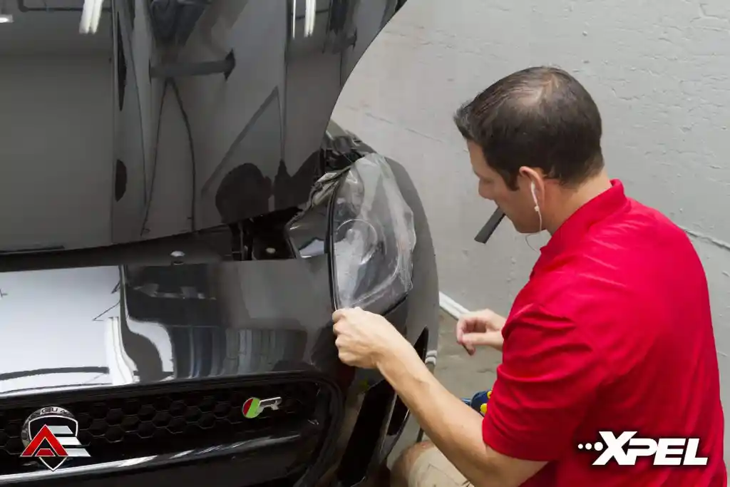 Paint protection film being applied to the headlight of a Jaguar F-TYPE R