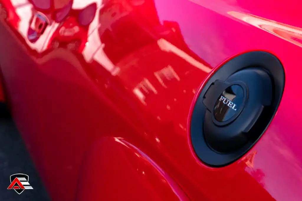 Close-up of a Dodge Challenger Demon fuel cap on a red quarter panel
