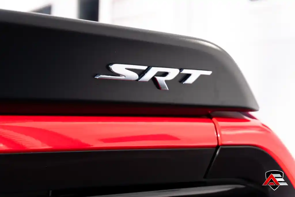 Close-up of the SRT badge on a Dodge Challenger rear spoiler