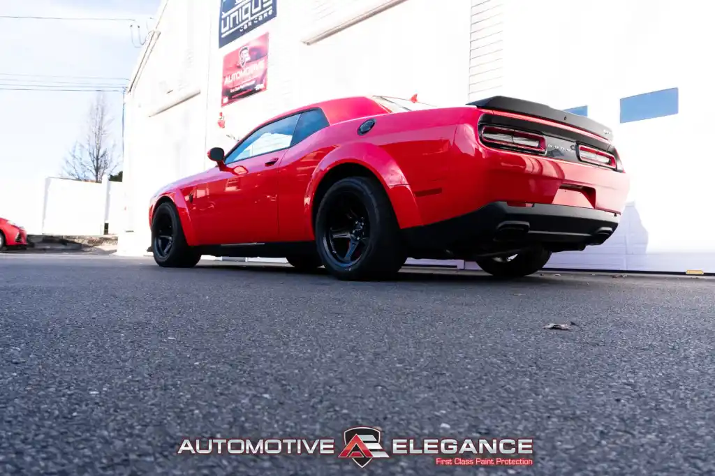 Rear three-quarter view of a red Dodge Challenger SRT Demon parked outdoors
