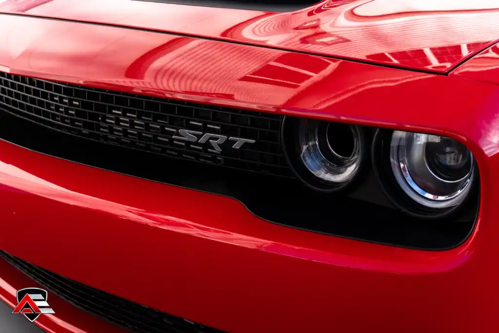 Front grille and headlight close-up of a red Dodge Challenger SRT Demon