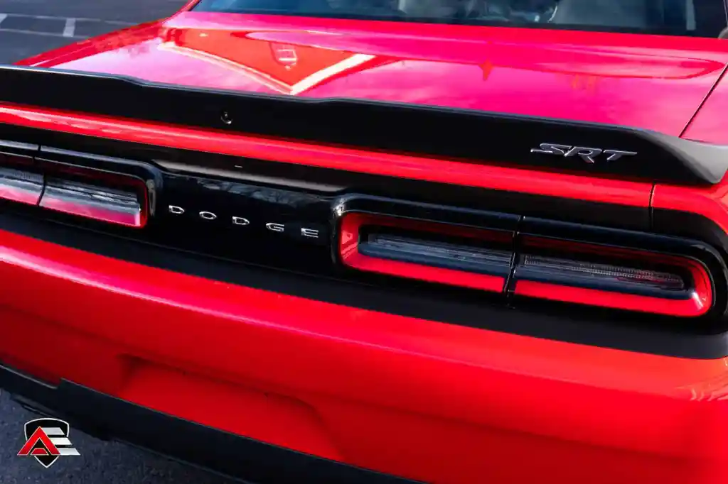Rear taillight and spoiler detail of a red Dodge Challenger SRT Demon