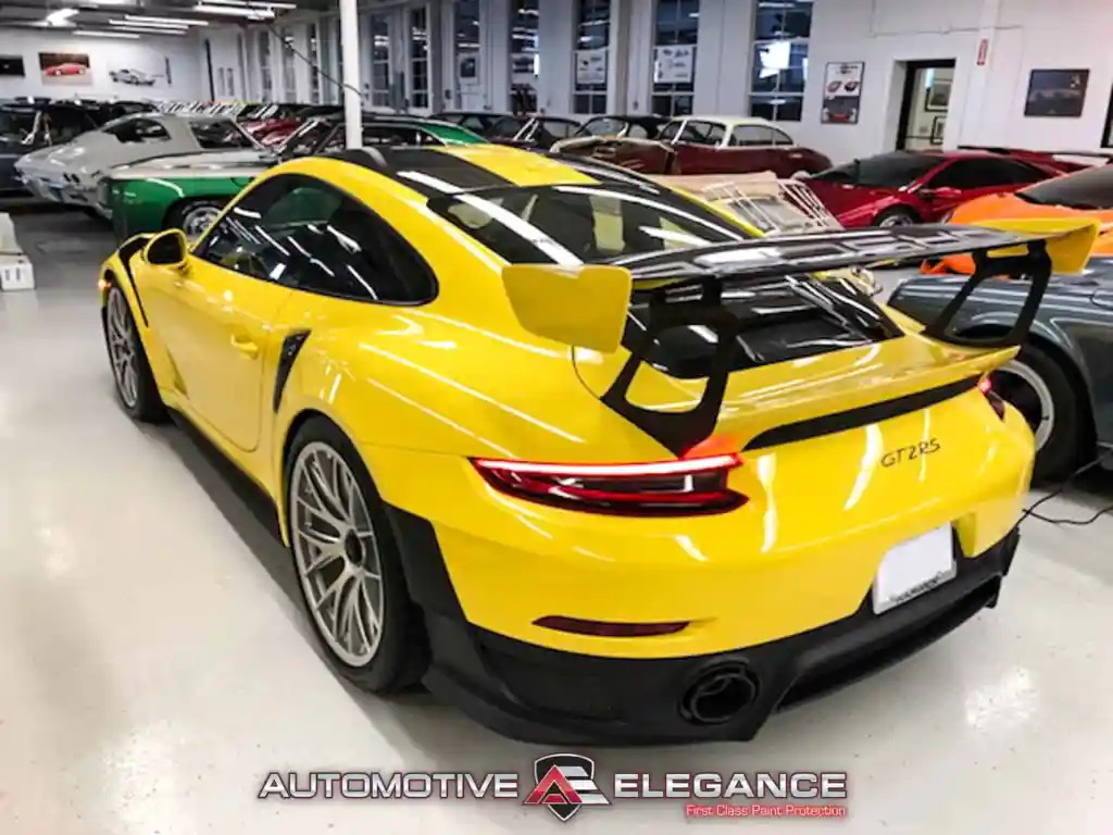 Rear three-quarter view of a yellow Porsche 911 GT2 RS with large rear wing