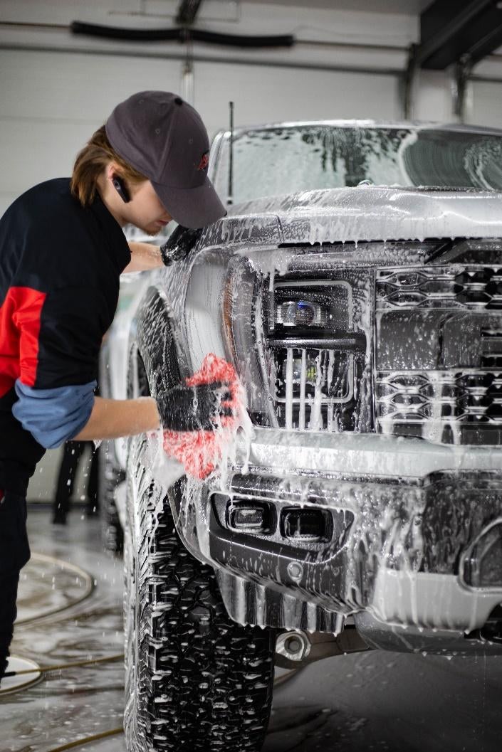 Nate using the microfiber mitt to wash the Raptor