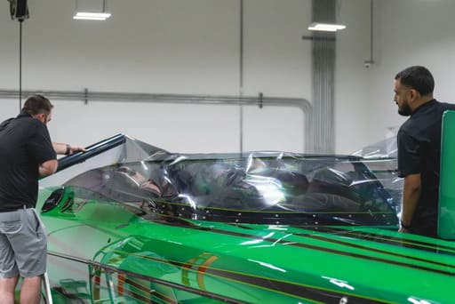 two guys window tinting a boat