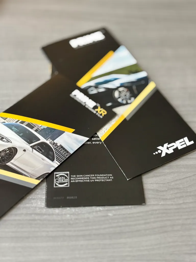XPEL window tint sample cards displayed on a tabletop